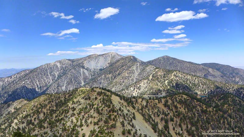 Mt. Baldy and surrounding peaks from Telegraph Peak. Baldy Bowl is the bare granite-colored area down and to the left of the summit of Mt. Baldy. The Ski Hut is in the trees to the right of the bottom of the bowl. The Ski Hut/Baldy Bowl Trail crosses along the bottom of the bowl, then switchbacks up the forested slope on its left, eventually working up the ridge above the bowl.