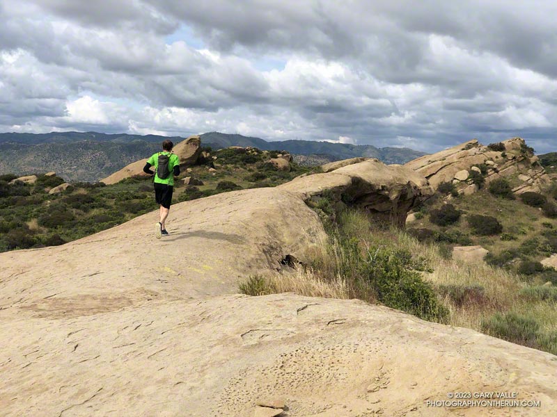 Running along upthrust sandstone rocks at Sage Ranch Park.