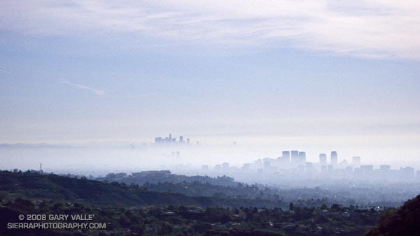 An offshore wind scours out low-lying fog trapped in the Los Angeles basin by a low altitude temperature inversion.