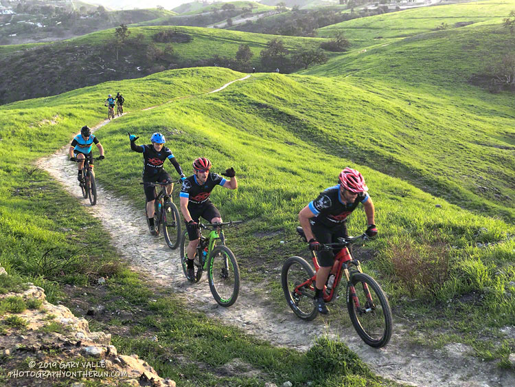 Mountain bikers climbing a small hill at Ahmanson Ranch