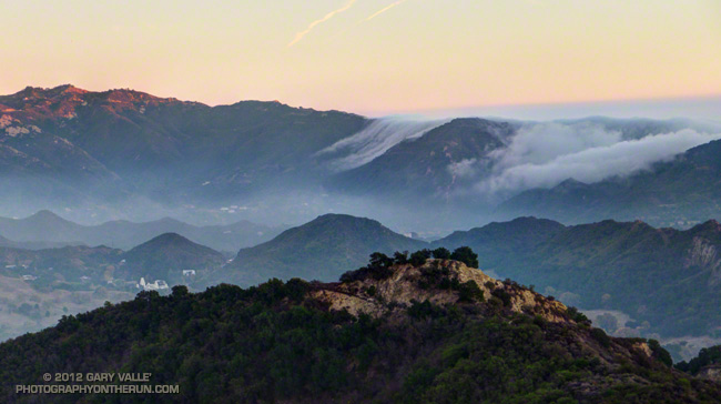 The marine layer spills over the crest of the Santa Monica Mountains