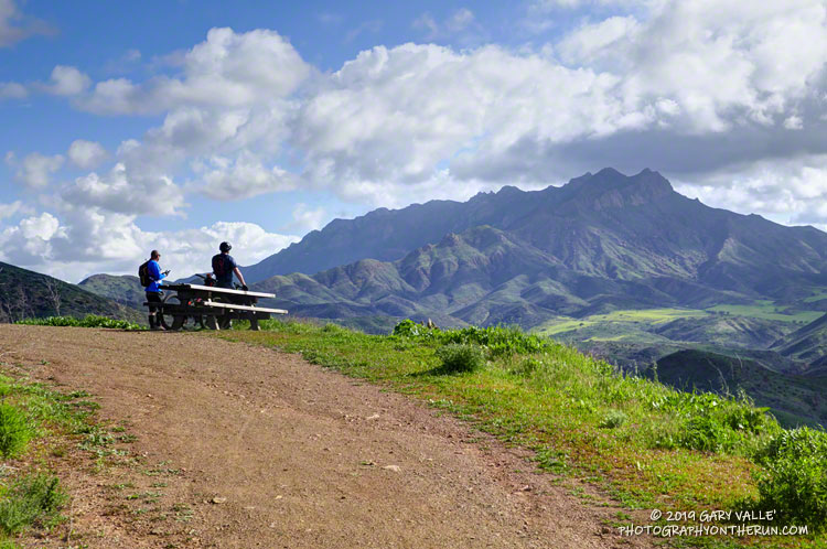 Mountain bikers enjoying the view of Boney Mountain from Overlook Fire Road in Pt. Mugu State Park.