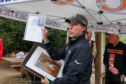 Four-time Olympian, Rod Dixon, presents Jon Sutherland with a print of a painting by Tom Ogiela of Herb Elliott's world record-setting gold medal finish in the 1500m in the 1960 Rome Olympics.