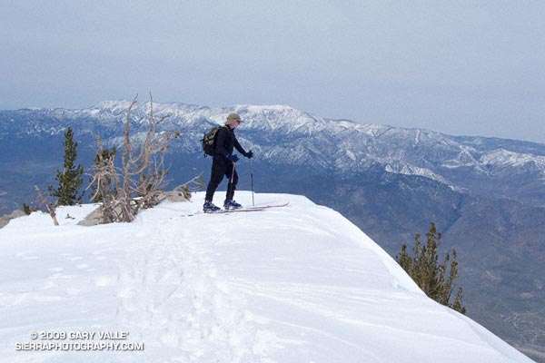 Charles Foster on the summit of San Jacinto Peak. San Gorgonio Mountain is in the background.