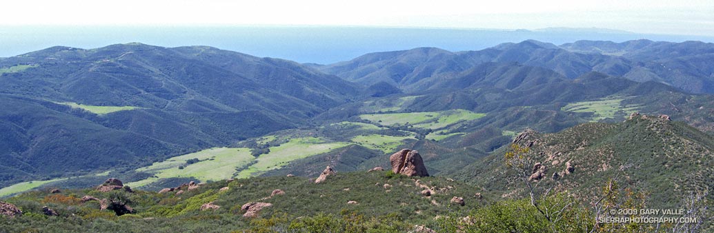 A composite photograph of Chamberlain Rock and Serrano Valley from the Chamberlain Trail segment of the Backbone Trail, with La Jolla Valley and the Channel Islands in the distance.