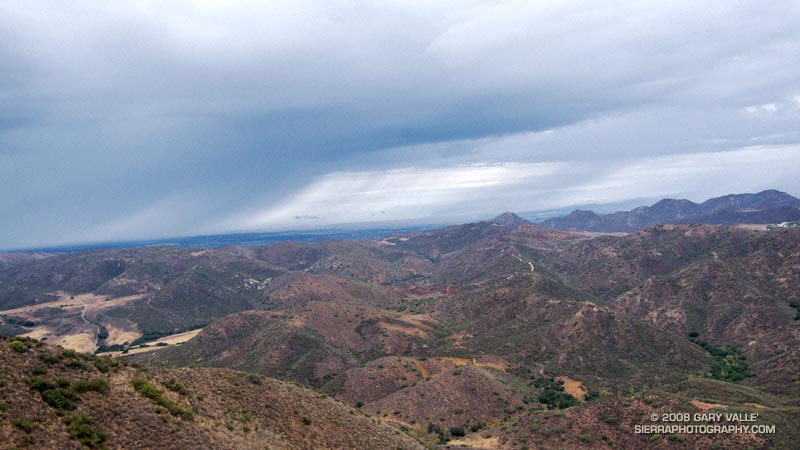 Thunderstorm marching northeast from the Santa Barbara Channel across the Oxnard Plain. Big Sycamore Canyon is in the foreground.