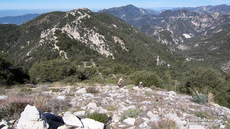 Descending to Tom Sloan Saddle. Bear Canyon is on the right, and leads down to Arroyo Seco. Angeles Crest Highway (Hwy 2) can be seen in the distance.