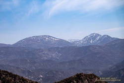 Hazy view of snow on Mt. Waterman and Twin Peaks from the Condor Peak Trail.