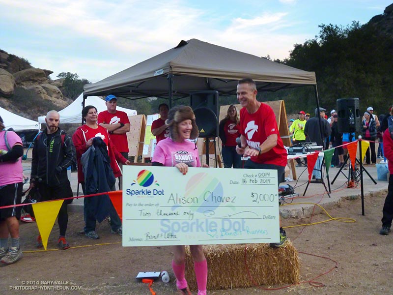 Bandit Trail Runs race director Randy Shoemaker presents a check to Alison Chavez to help in her battle against cancer. A dedicated runner, Alison ran and completed the Bandit 30K.