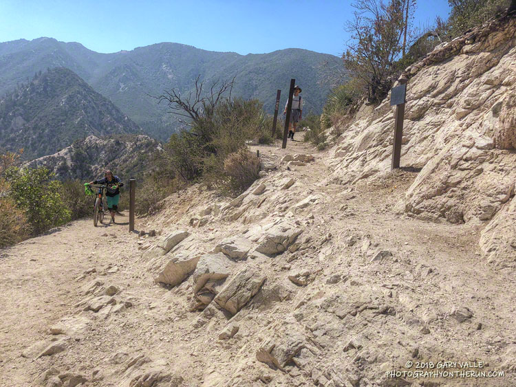 The Bear Canyon Trail - Gabrielino Trail junction. The mountain biker had missed the turn onto the trail on the right (with the hiker), which leads to JPL.
