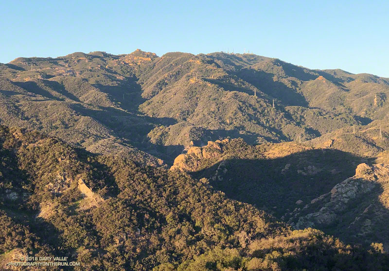 The normal route of the Bulldog loop follows Crags Road along the narrow canyon cut by Malibu Creek. Then using Bulldog Mtwy fire road it ascends the broad ridge in the upper center of the photo to Castro Peak Mtwy and the Castro Crest.