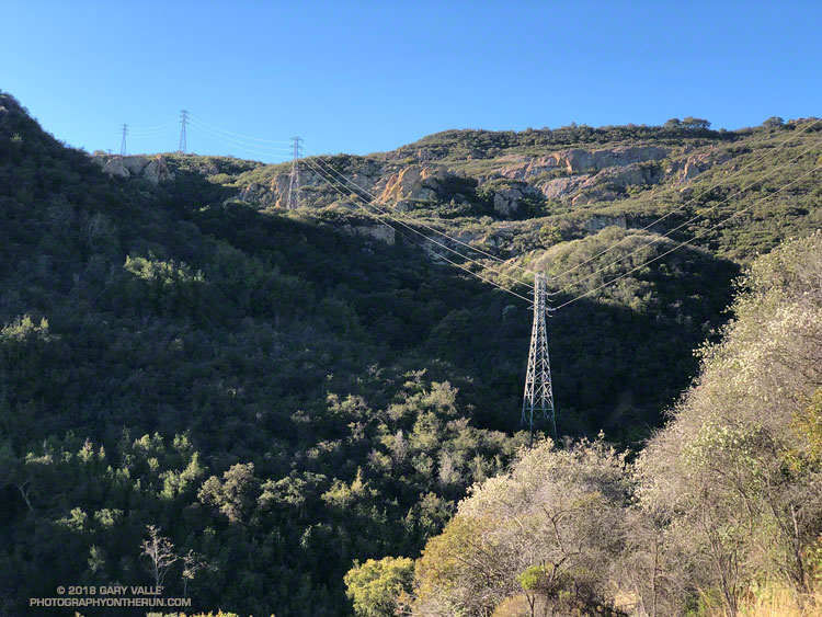 The gap in the power line service roads is between the bottom two towers. The tower on the skyline is at Castro Peak Mtwy fire road.