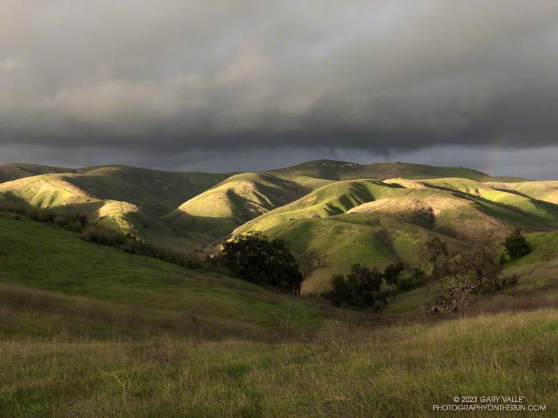 Amazing lighting on the hills of Ahmanson Ranch. There is just the hint of a rainbow on the right.