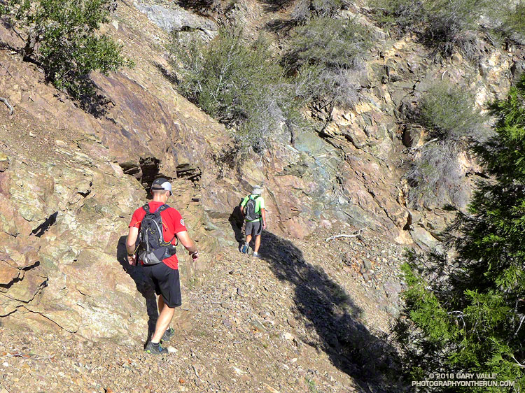 Runners on the South Fork Trail. There are many (usually) small scree and rock slides on the trail. From a run in May 2013.