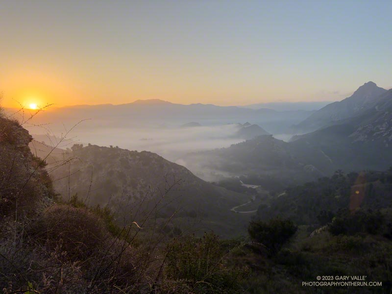 Hazy and foggy sunrise from an overlook of Malibu Creek State Park on the Cistern Trail. Saddle Peak is in the distance.
