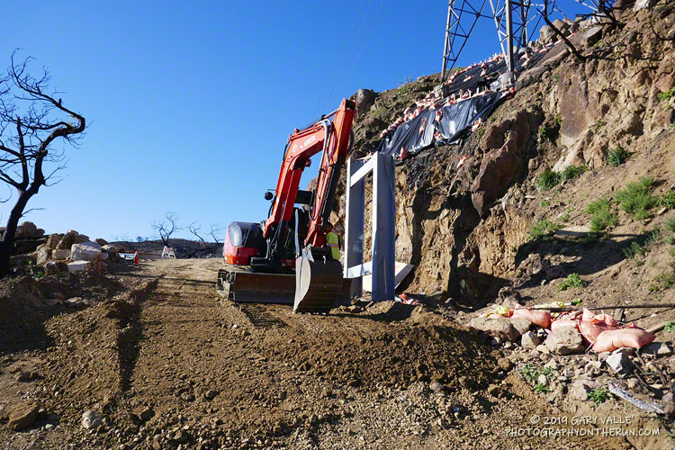 Repair work to stabilize the footing of a power transmission tower on Bulldog Mtwy.